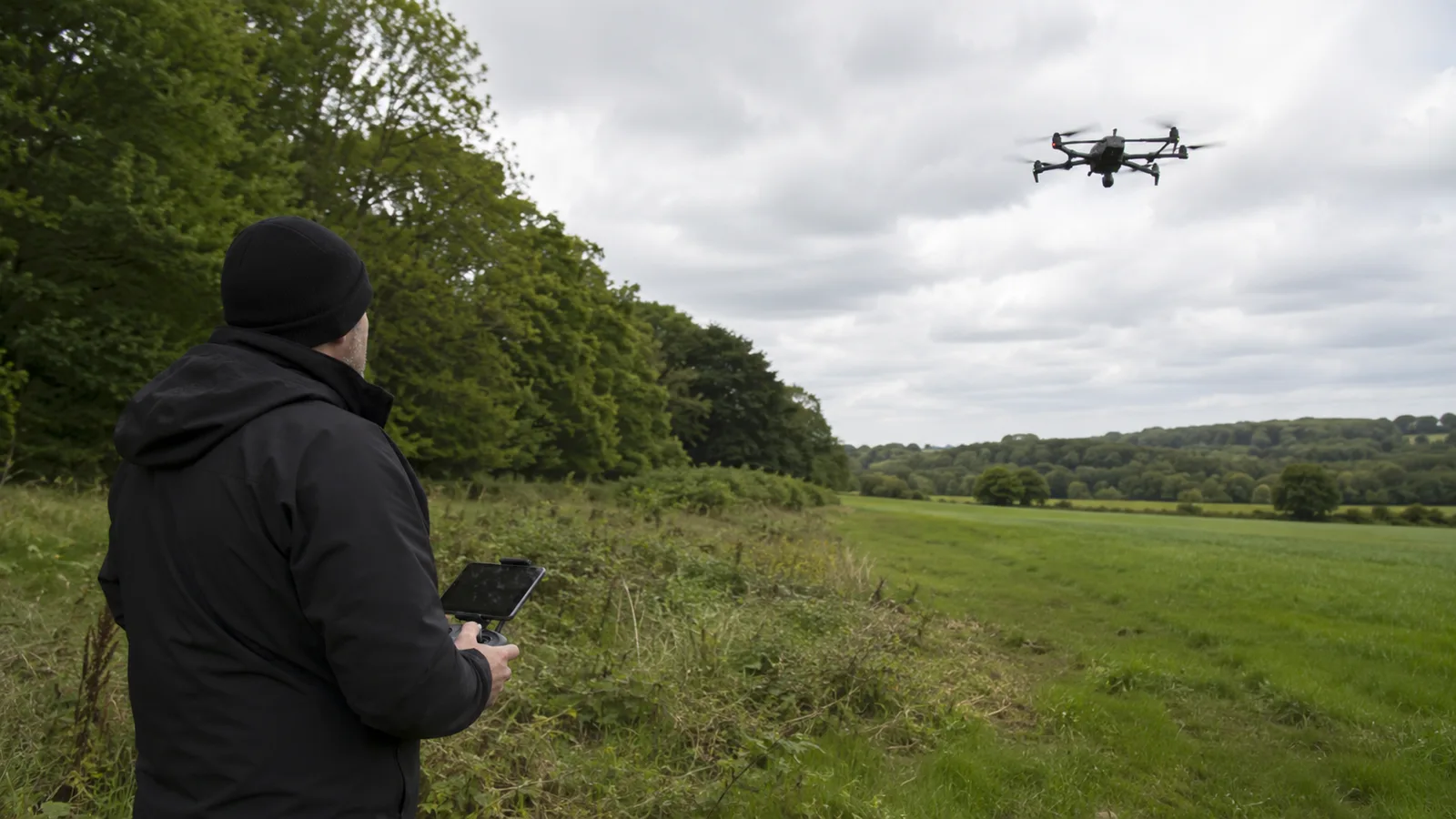 Professional drone pilot carrying out a missing pet search over UK farmland